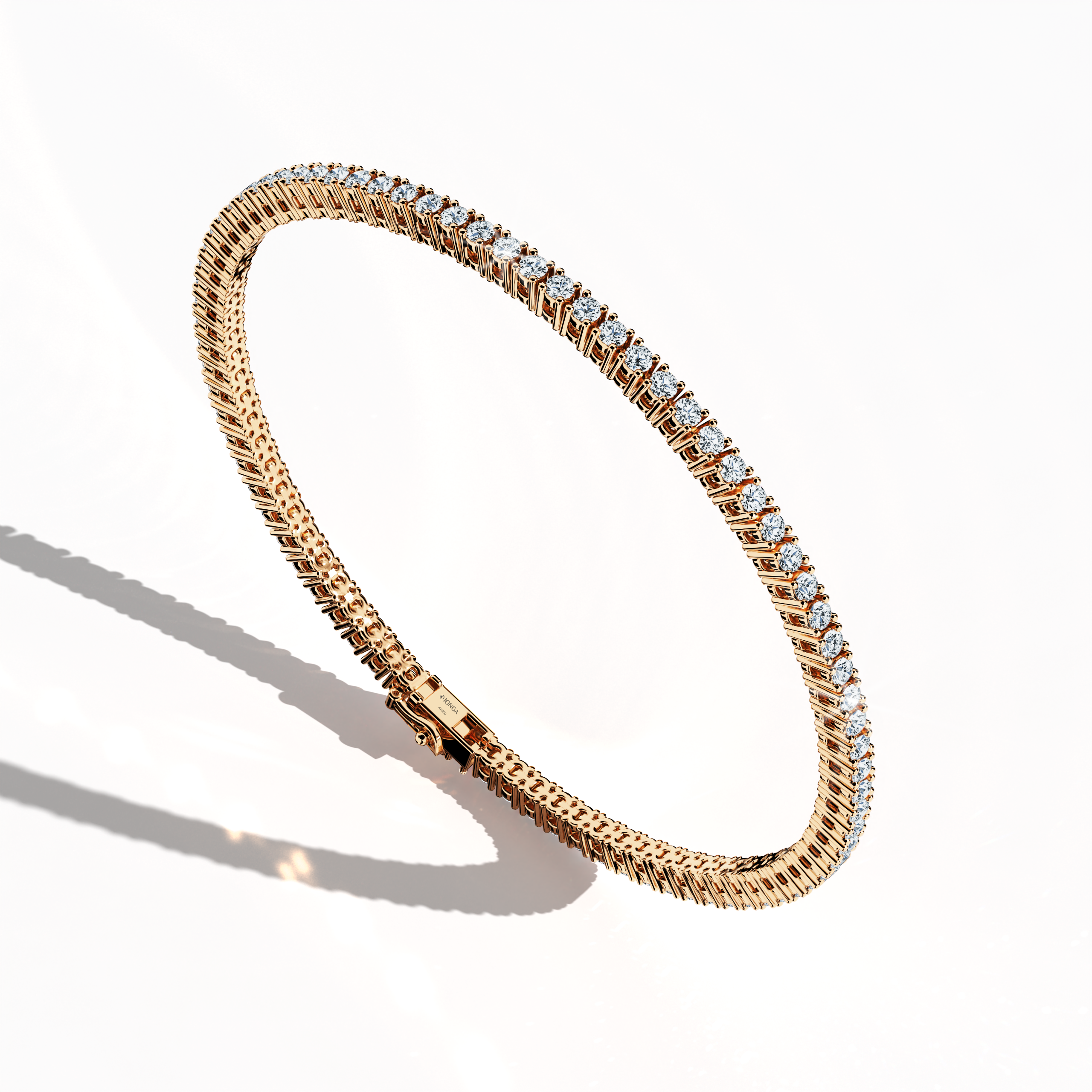 In a standing front top side view, this 3 carat diamond tennis bracelet in rose gold (also referred to as pink gold or red gold) showcases prong-set round brilliant stones with a graceful curvature. Known as tennis bracelet, line bracelet, eternity bracelet, river bracelet, or inline bracelet, the four-prong setting accentuates each diamond’s fire. A versatile choice for elegant style. Keywords: diamond tennis bracelet, 3 carat, rose gold, jewelry, prong setting.