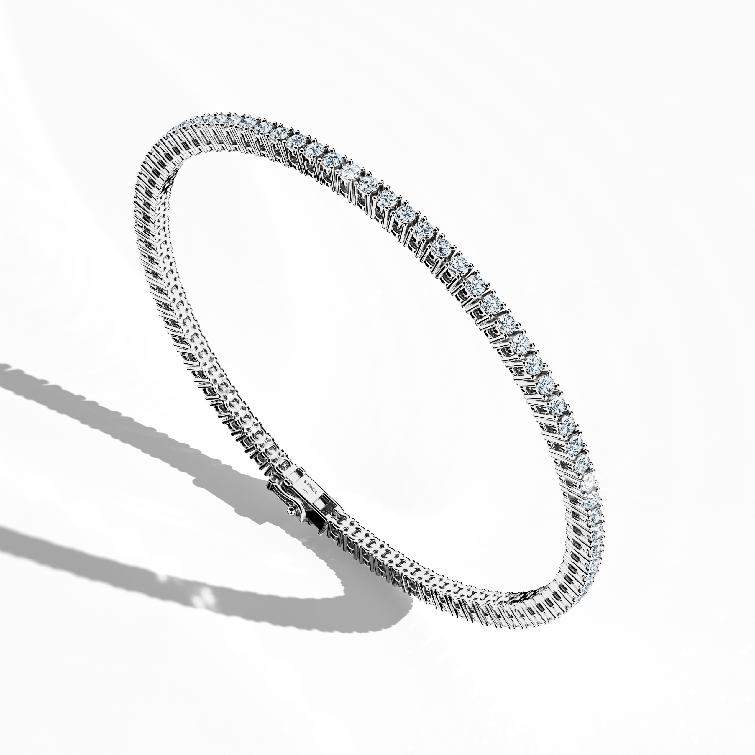 In a standing front top side view, this 3 carat diamond tennis bracelet in white gold (also referred to as grey gold or palladium gold) showcases prong-set round brilliant stones with a graceful curvature. Known as tennis bracelet, line bracelet, eternity bracelet, river bracelet, or inline bracelet, the four-prong setting accentuates each diamond’s fire. A versatile choice for elegant style. Keywords: diamond tennis bracelet, 3 carat, white gold, jewelry, prong setting.