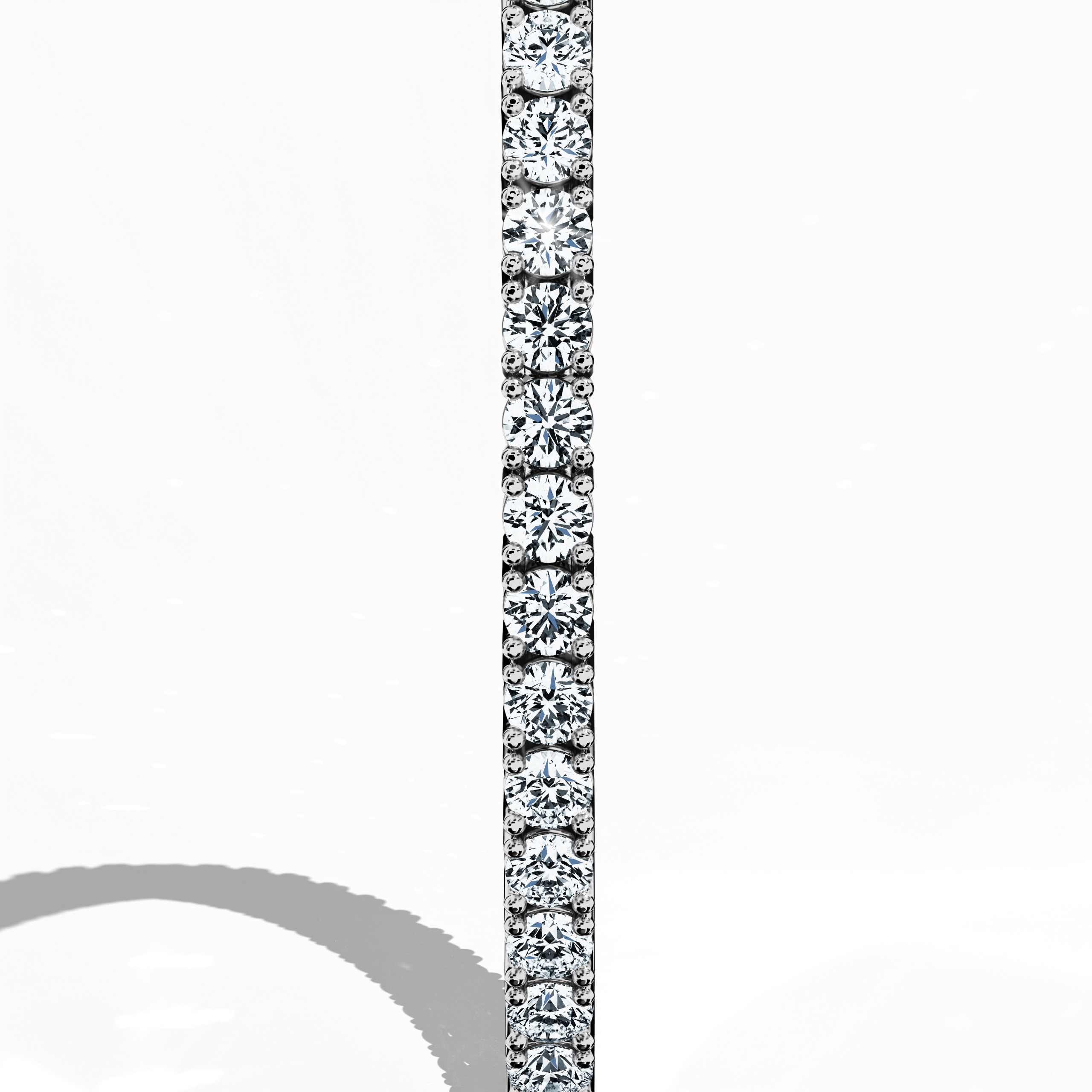 This 6-carat diamond tennis bracelet in white gold (often called grey gold or palladium gold) is captured from a standing side perspective, revealing its fluid silhouette and continuous row of round diamonds. Also named a line bracelet, eternity bracelet, river bracelet, or inline bracelet, it features a secure clasp for daily wear. An icon of refined style, it shines for both casual and formal occasions. Keywords: diamond tennis bracelet, white gold, line bracelet.