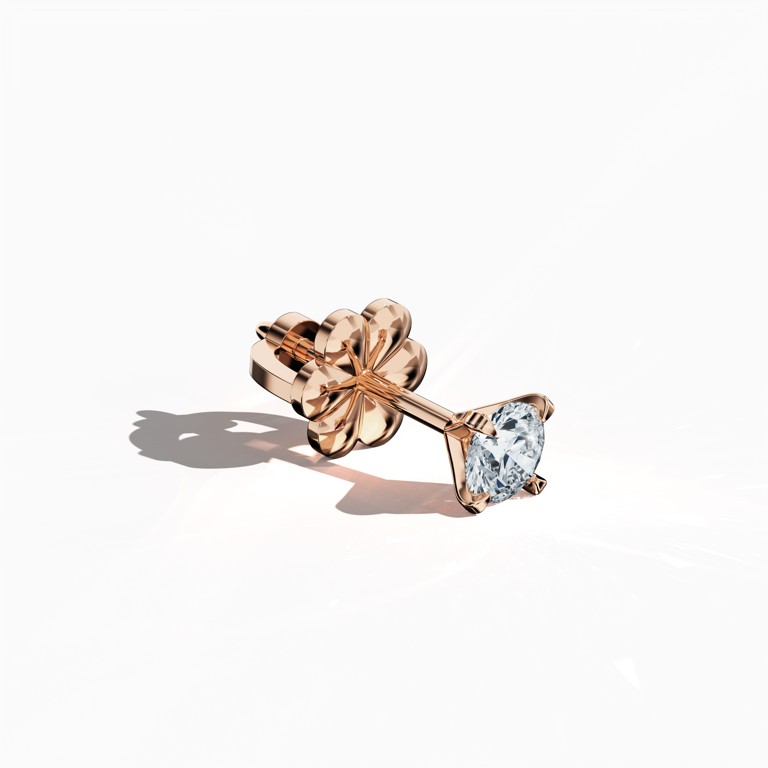 Front top side view of 0.60 carat natural diamond earring in 18k rose gold with nail prong setting; diamond stud, 0.60ct solitaire diamond, luxury fine jewelry/fine jewellery ear accessory.