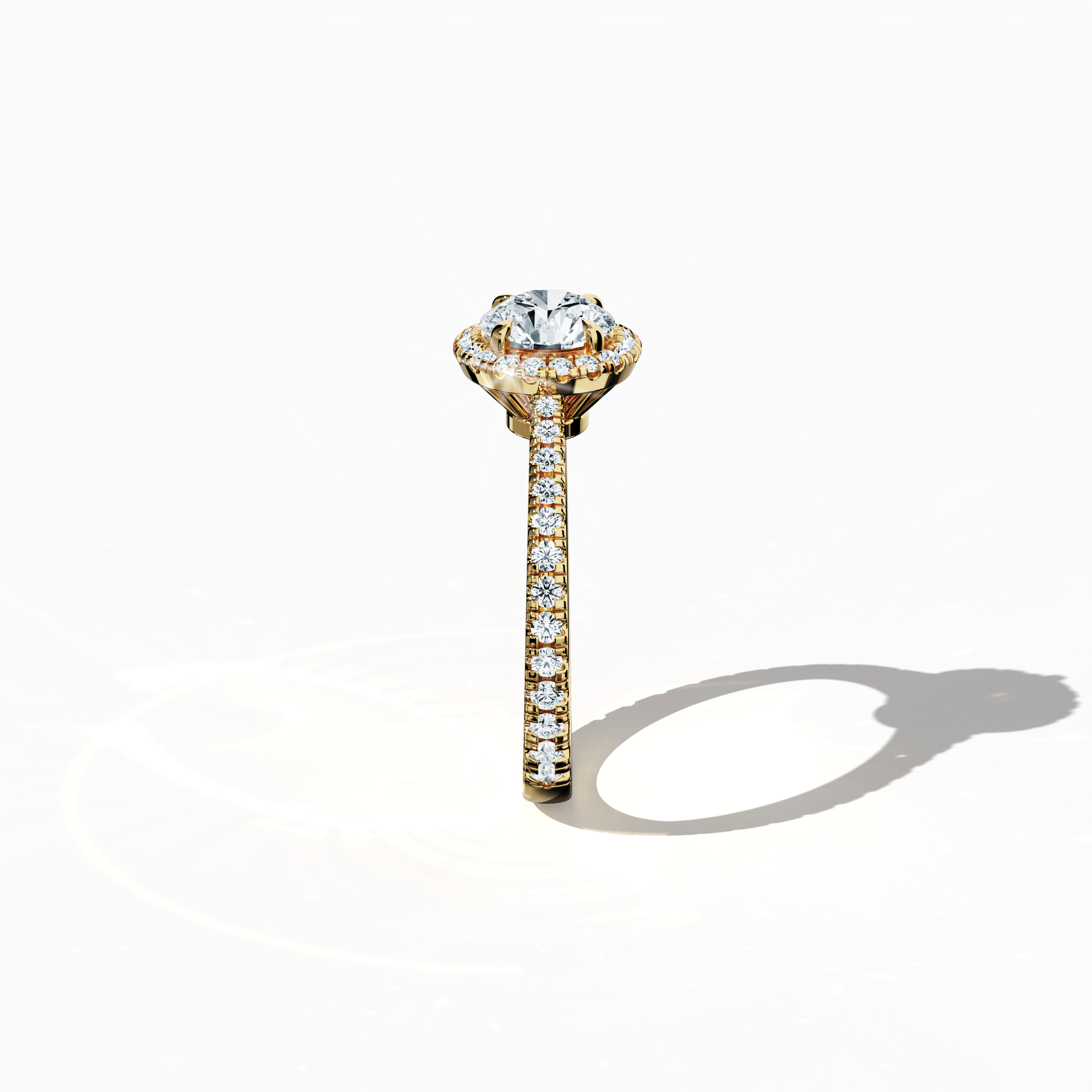 Detailed standing side view of a yellow gold halo paved ring accentuating its elegant profile and gracefully curved band featuring a 1ct round‐cut center diamond paired with a 0.60ct side diamond halo. The lateral angle reveals intricate pavé details in rich yellow, sun, and traditional gold tones, blending influences of classic halo, vintage halo, modern halo, and bridal halo designs. Keywords: refined, round brilliance, artisanal, luxury, contemporary style.