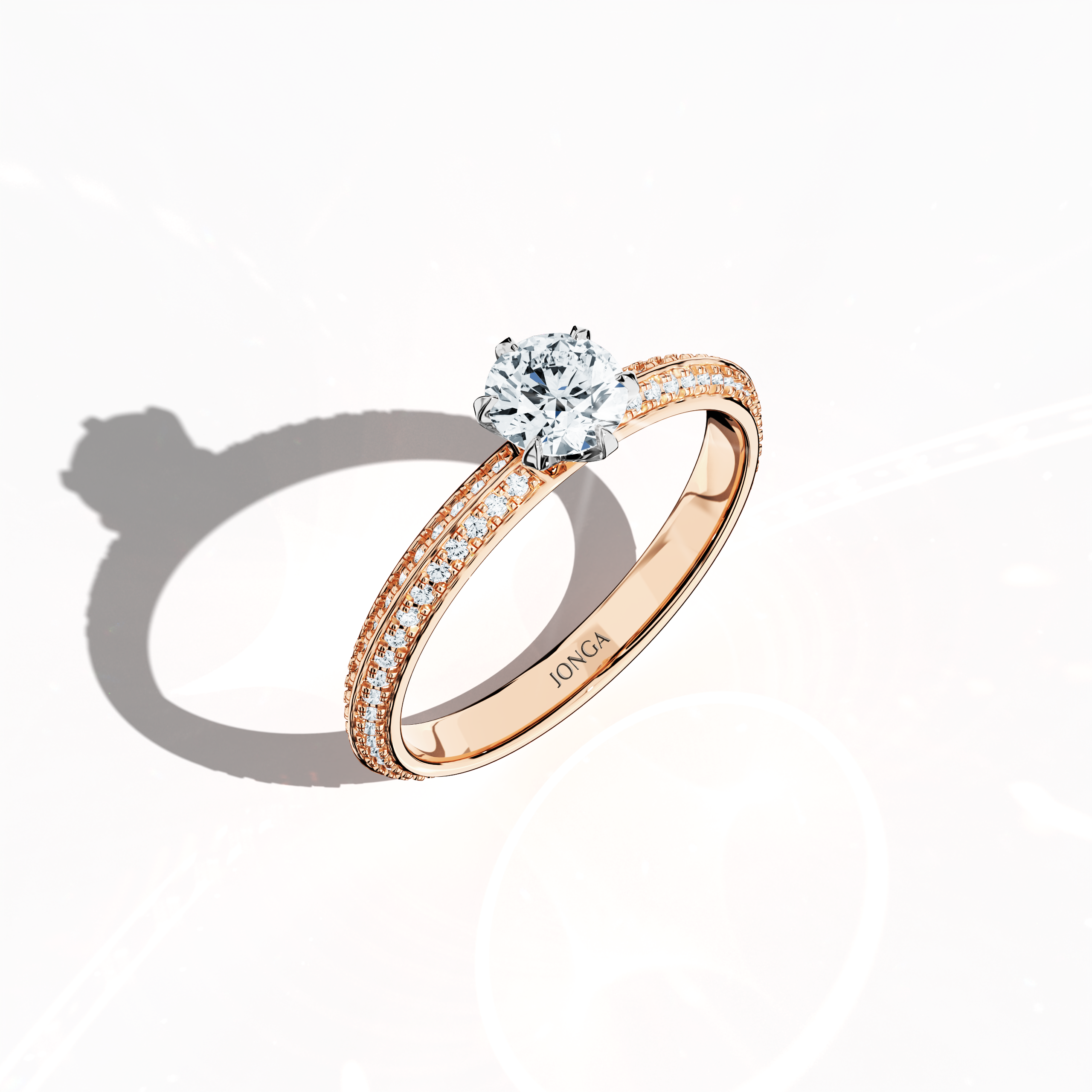Modern 0.90 ct solitaire paved ring featuring a 0.50 ct center diamond and 0.40 ct pavé side stones, set in soft rose gold (blush/pink gold) with a dual‑tier, step‑designed band and a defined central line. Captured from a front top side angle, this fine jewelry/fine jewellery ring emphasizes its intricate pavé setting and gentle, luminous finish.