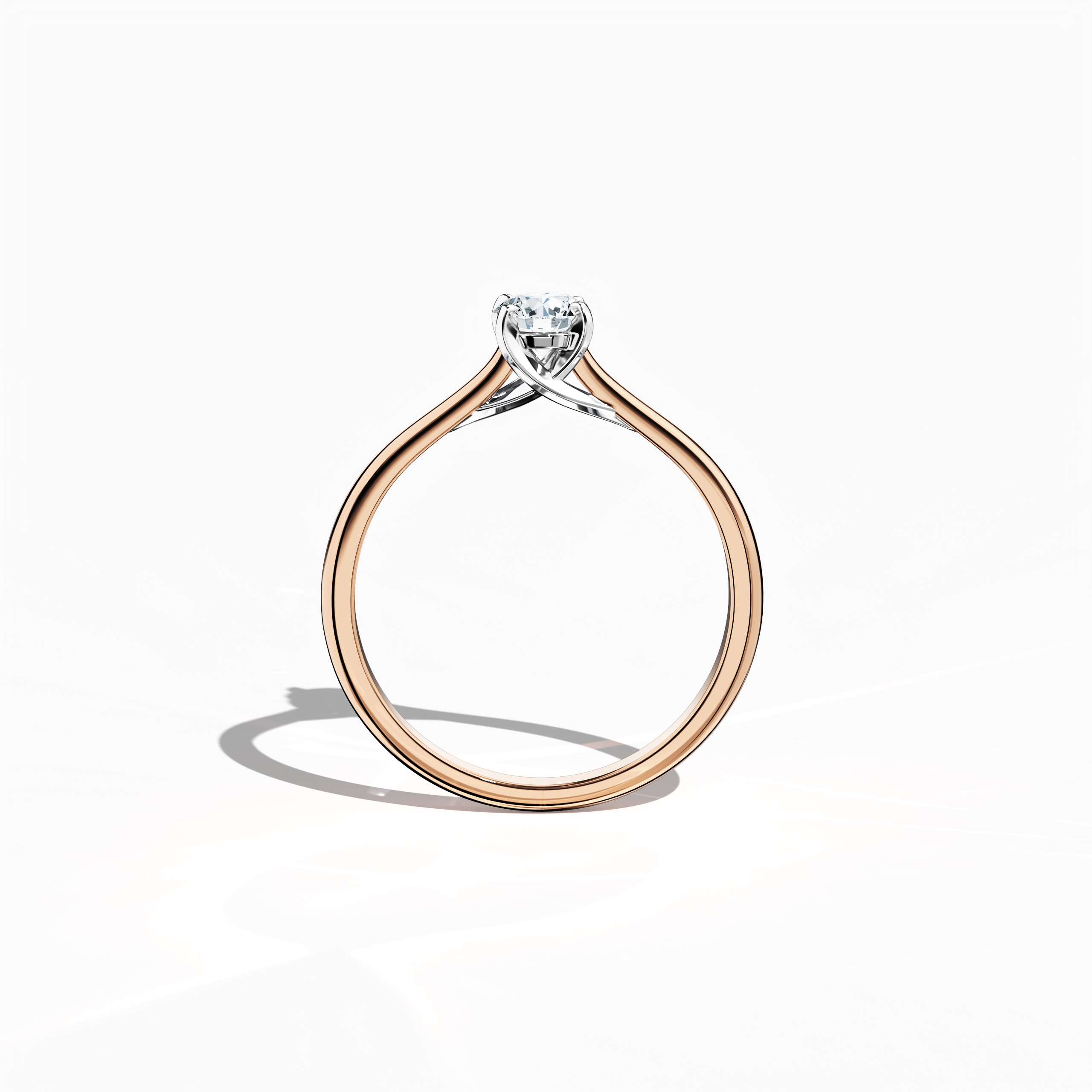 Refined solitaire diamond ring with a 0.30 ct center stone in a unique twisted bottom setting, secured by four‑tap prongs in white gold and paired with a soft rose gold band (blush/pink gold). Shown from a standing front view, this fine jewelry/fine jewellery ring exemplifies modern romance and sophisticated design.
