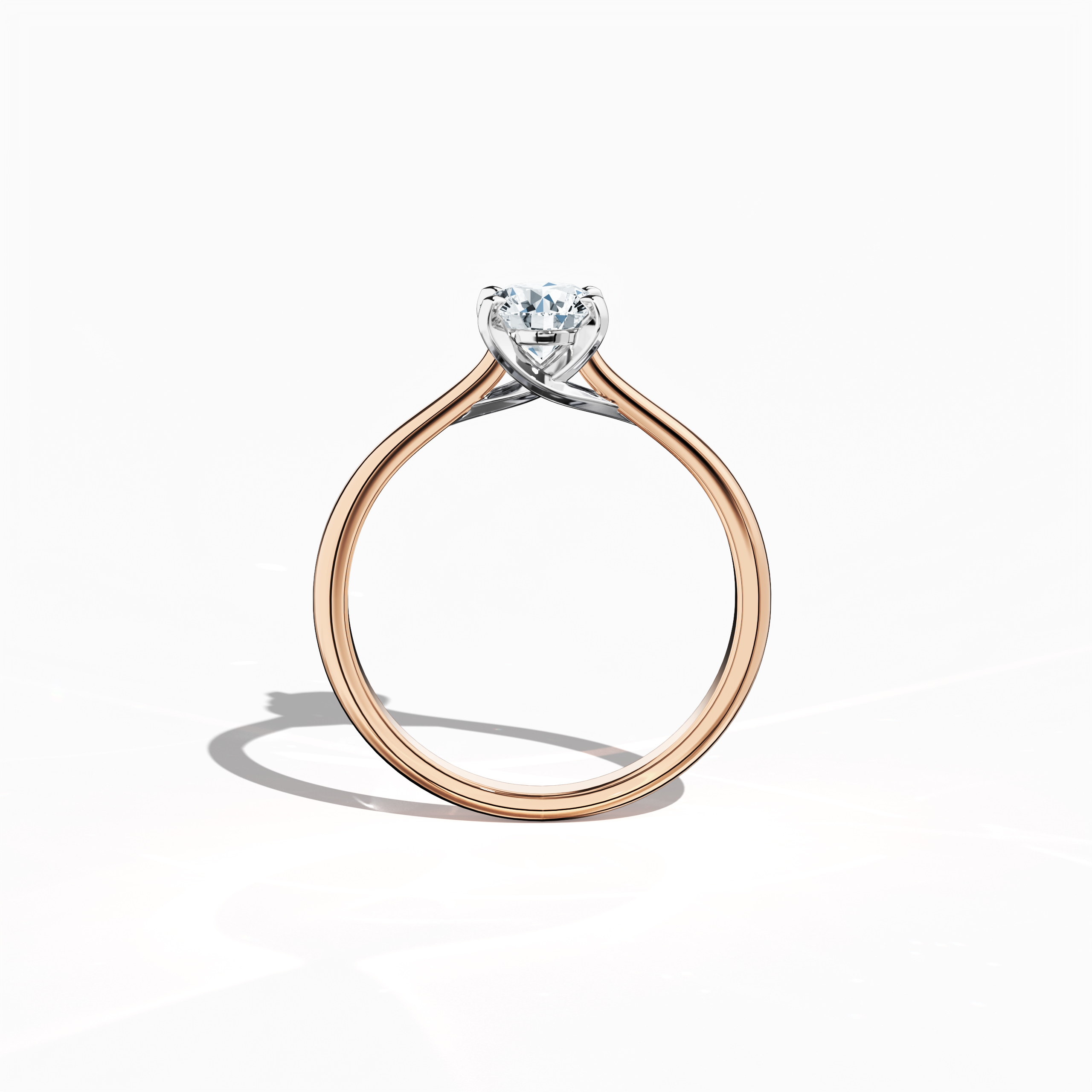 Refined solitaire diamond ring with a 0.70 ct center stone in a unique twisted bottom design and four‑tap prongs in white gold, paired with a soft rose gold band (blush/pink gold). Shown from a standing front view, this fine jewelry/fine jewellery ring exemplifies modern romance and sophisticated style.