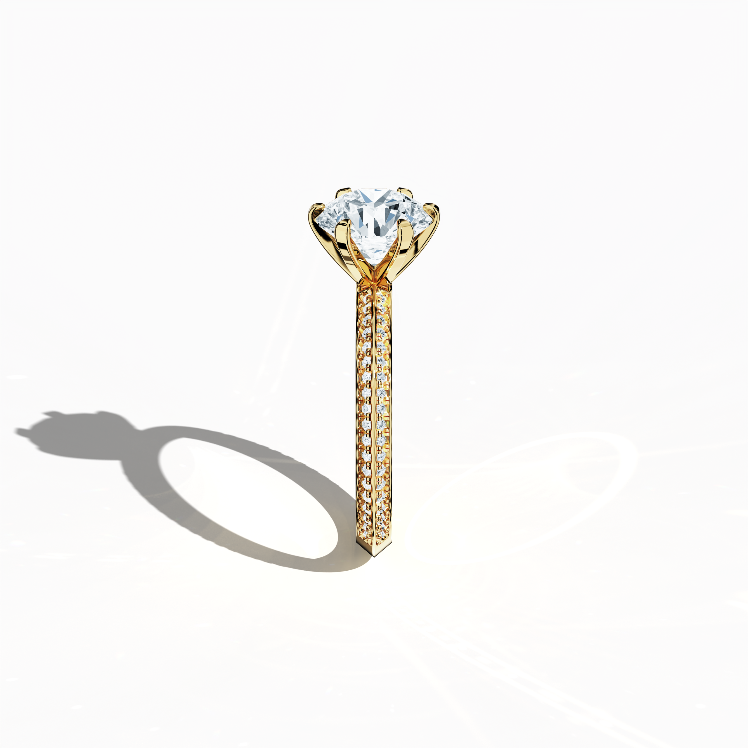 Refined solitaire paved ring with 2.40 ct total diamonds (2 ct center, 0.40 ct side stones) in a six‑prong baby claw setting and a two‑step band with a sharp central line, set in a rich yellow gold band. Photographed from a standing side view, this fine jewelry/fine jewellery ring showcases its elegant contours and vibrant, warm finish.