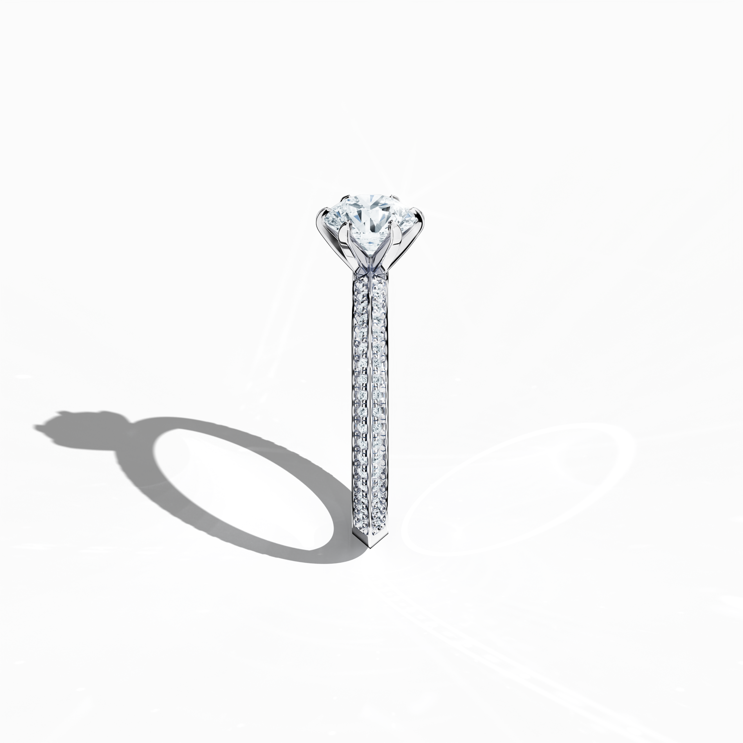 Refined solitaire paved ring with 1.40 ct diamonds – 1 ct center and 0.40 ct pavé side stones – set in bright white gold with a two‑step band featuring a defined central line. Photographed from a standing side view, this fine jewelry/fine jewellery ring showcases its sleek contours and exceptional diamond brilliance.