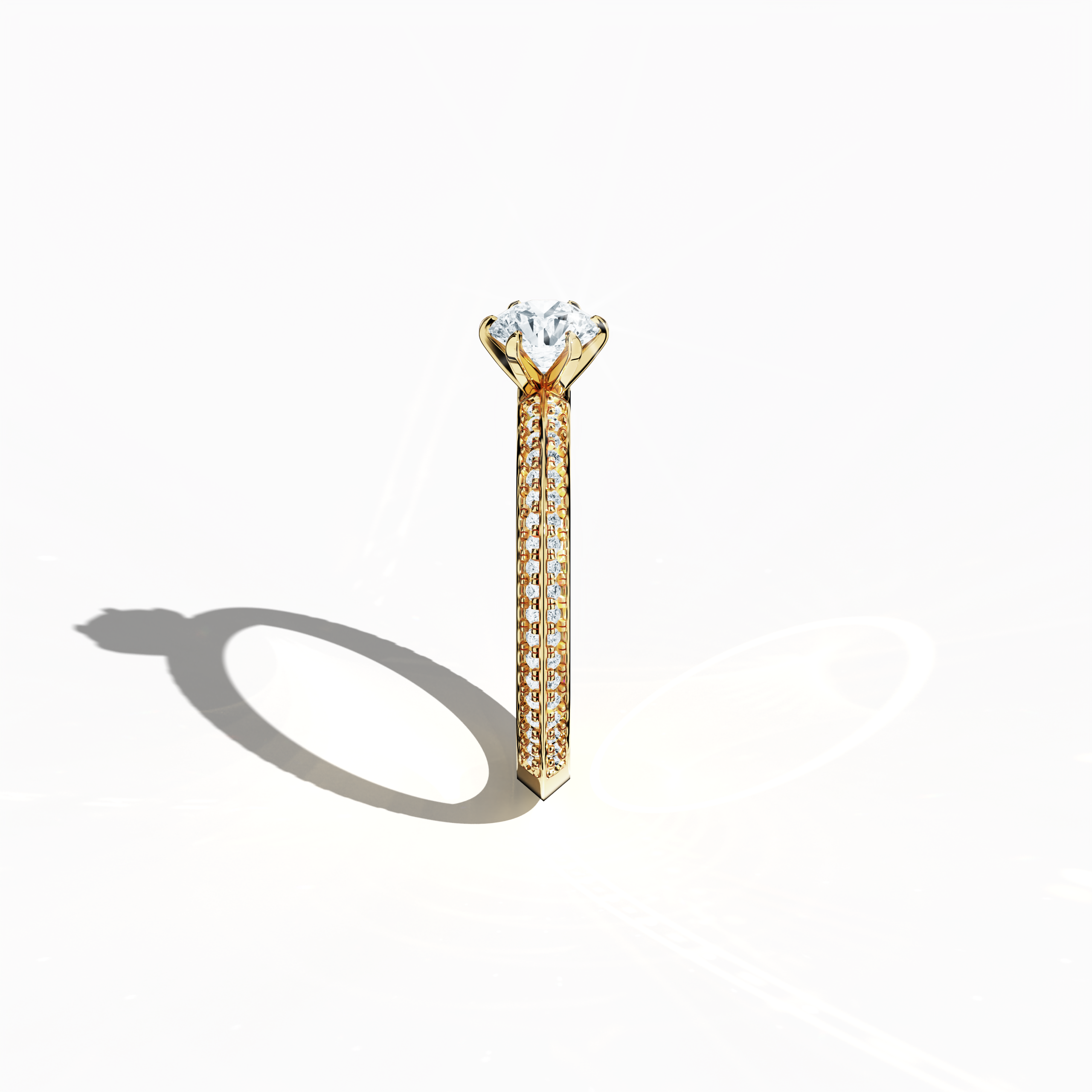 Refined solitaire paved ring with 0.90 ct total diamonds, featuring a 0.50 ct center stone and 0.40 ct pavé side stones, set in a rich yellow gold band with a two‑step band design and a sharp central accent. Photographed from a standing side view, this fine jewelry/fine jewellery ring showcases elegant contours and a vibrant, warm finish.