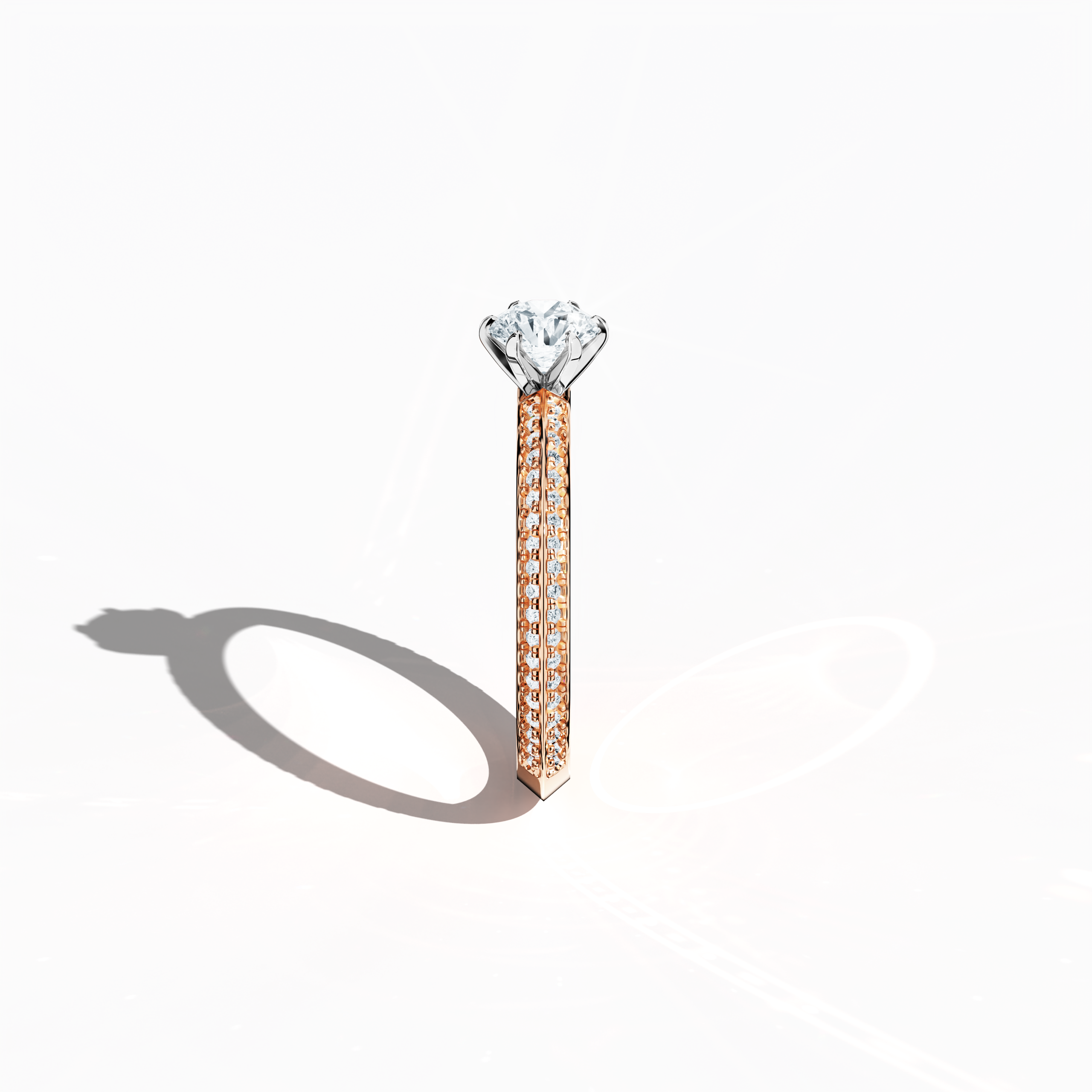 Refined solitaire paved ring with 0.90 ct of diamonds, featuring a 0.50 ct center stone and 0.40 ct pavé side stones, set in soft rose gold (blush/pink gold) with a two‑step band design marked by a sharp central line. Photographed from a standing side view, this fine jewelry/fine jewellery ring showcases its elegant contours and warm, romantic allure.