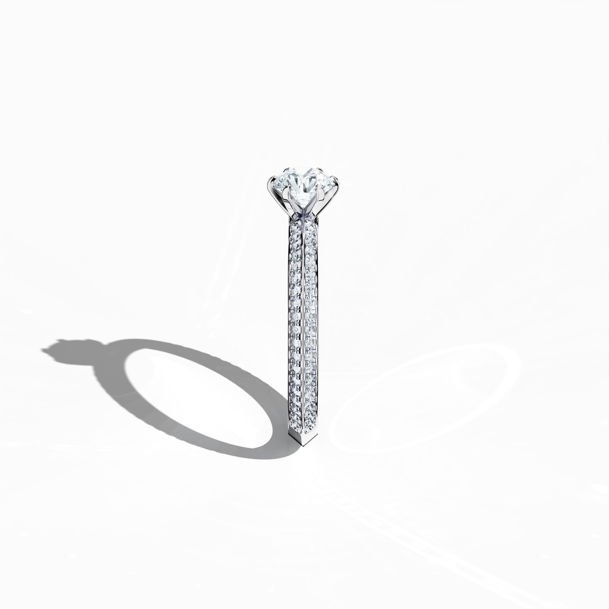 Refined solitaire paved ring with 0.90 ct of diamonds – a 0.50 ct center diamond and 0.40 ct pavé side stones – set in bright white gold with a two‑step band featuring a defined central line. Photographed from a standing side view, this fine jewelry/fine jewellery ring showcases its clean contours and exceptional diamond brilliance.