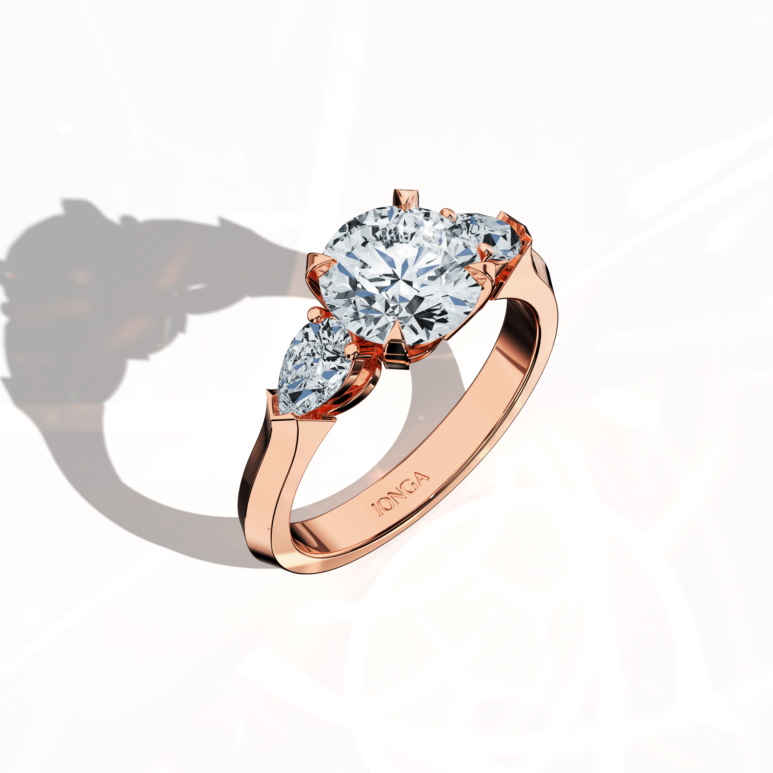 Front top side view of a rose gold trilogy diamond ring displaying 2.55 ct natural diamonds—a 2 ct round center/centre diamond with two pear‐shaped side diamonds (0.55 ct total) set in an elegantly slim band with a four‐nail prong design. This dynamic view reveals intricate detailing and balanced brilliance, ideal as an engagement ring, wedding band, or fine jewelry/fine jewellery piece. Also known as a trilogy ring, three‐stone ring, three‐diamond ring, trinity ring, and triptych ring design.