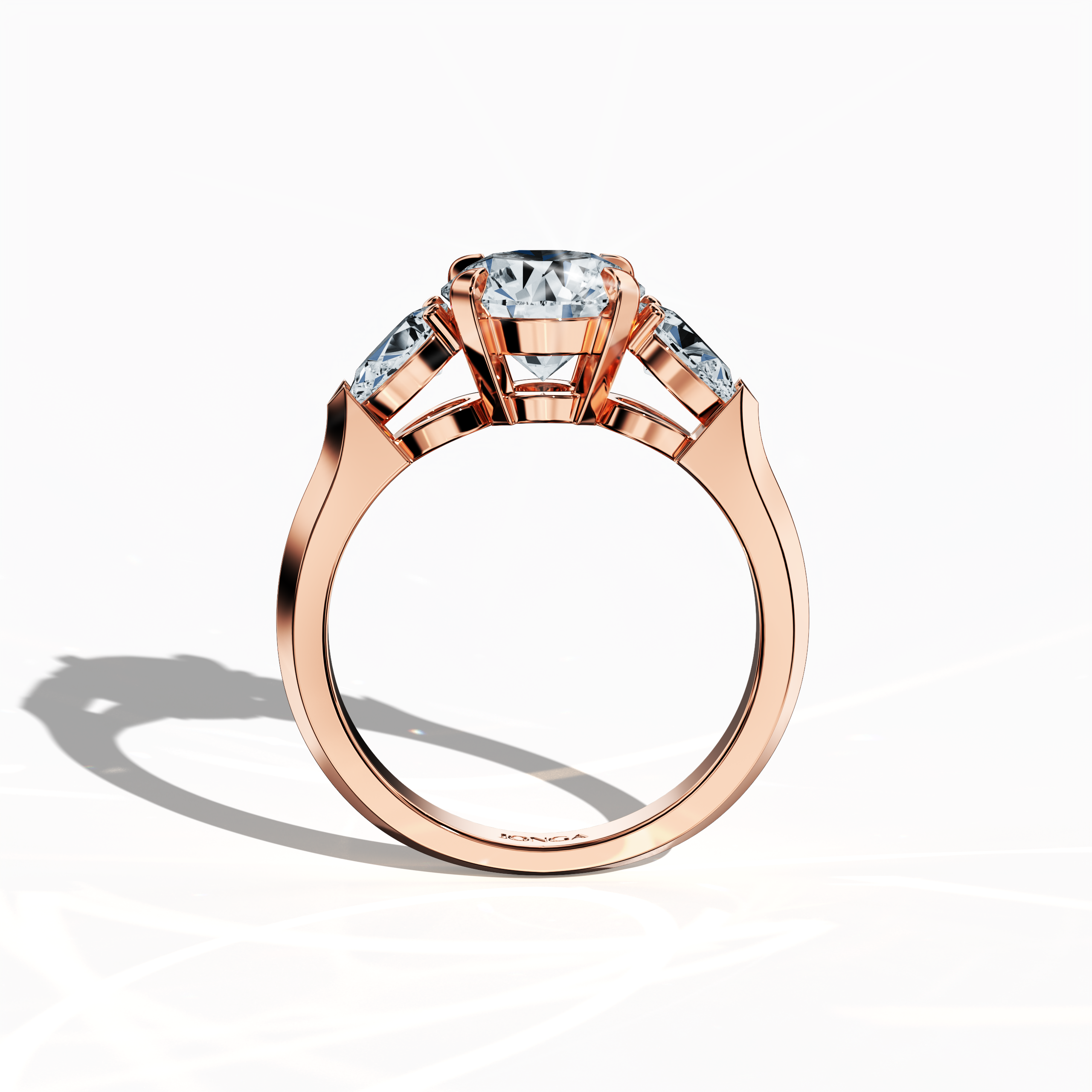 Standing front view of a rose gold trilogy diamond ring featuring 2.55 ct natural diamonds, with a striking 2 ct round center/centre diamond flanked by two pear‐shaped side diamonds (0.55 ct total) in a sleek band and secure four‐nail prong setting. Its modern design and warm blush tone make it ideal as an engagement ring, wedding band, or fine jewelry/fine jewellery statement piece. Also known as a trilogy ring, three‐stone ring, three‐diamond ring, trinity ring, and triptych ring design.