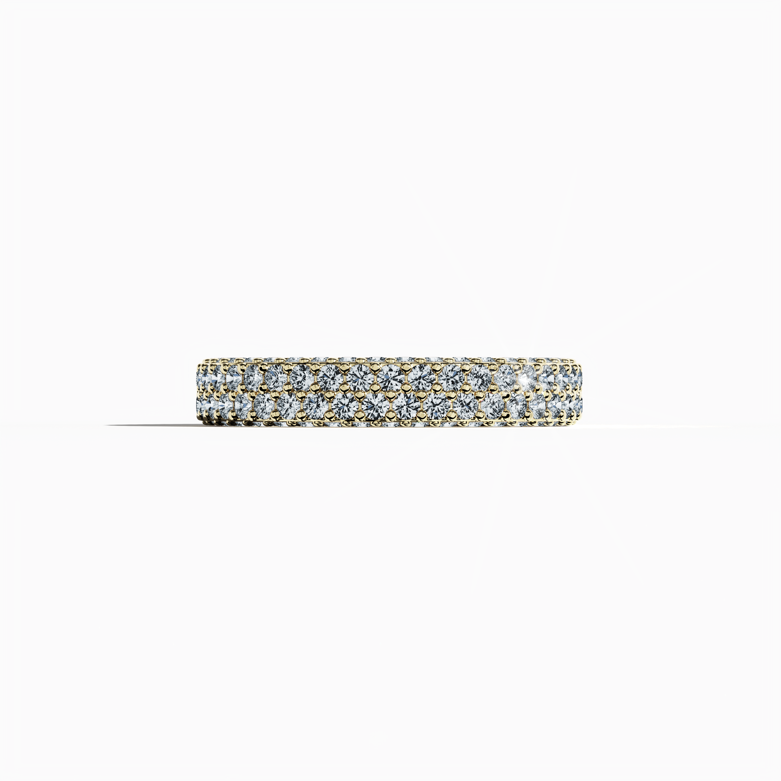 Exquisite yellow gold 4-row diamond band in a sleeping front view, featuring up to 2.10 carats of meticulously arranged micro diamonds. This remarkable design, known globally as an eternity band, classic pave band, multi-row diamond band, and luxury diamond band, boasts a radiant sun-kissed gold finish with detailed engravings and balanced contours. The image captures vibrant reflections and exceptional craftsmanship, symbolizing modern luxury and timeless allure. Keywords: yellow gold, micro diamonds.