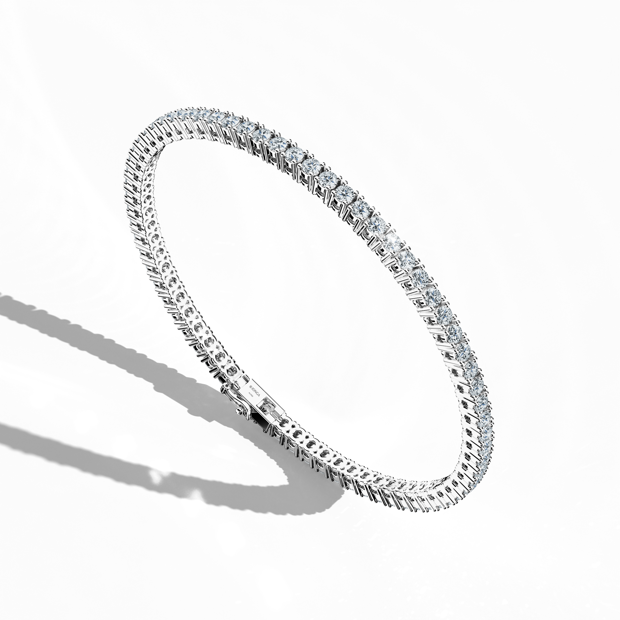 In a standing front top side view, this 4 carat diamond tennis bracelet in white gold (alternatively called grey gold or palladium gold) exhibits a gently curved band adorned with prong-set round brilliant diamonds. Also known as a tennis bracelet, line bracelet, eternity bracelet, river bracelet, or inline bracelet, its precise four‐prong design enhances the fire and brilliance of each gem. Perfect for accentuating both special occasions and upscale daily ensembles. Keywords: diamond tennis bracelet, 4 car