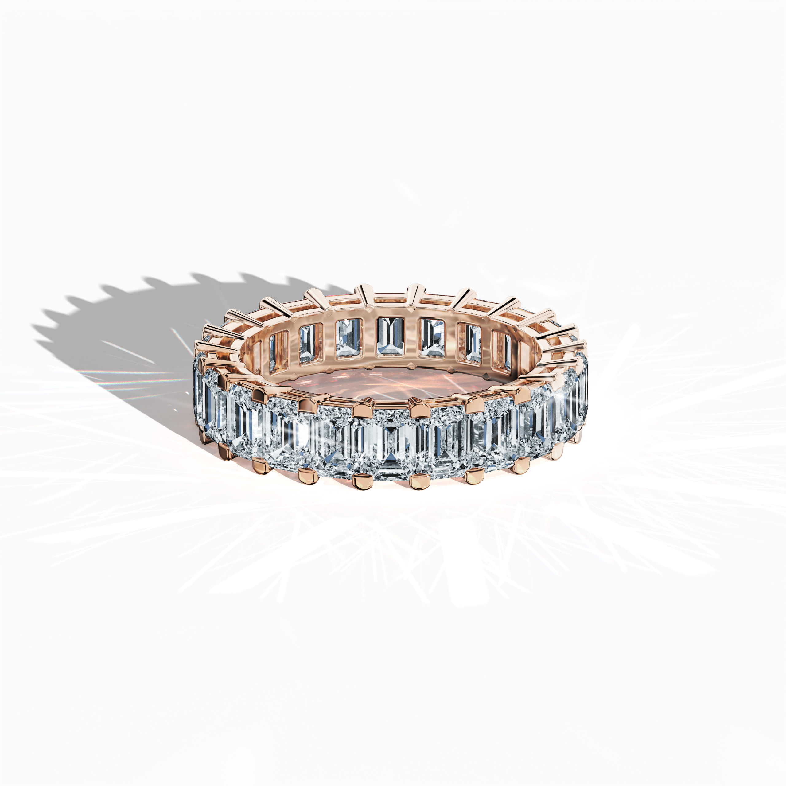 Displayed from an artful sleeping front top view, this captivating Emerald Eternity ring in alluring rose gold—alternatively known as pink or blush gold—exemplifies modern luxury. Recognized by design titles like Eternal Emerald, Infinity Emerald, and Everlasting Allure, the ring is adorned with up to 24 exquisitely set diamonds weighing 4.55 carats that elegantly frame a vibrant emerald centerpiece. Keywords: fine jewelry, timeless elegance, innovation, superior craftsmanship.