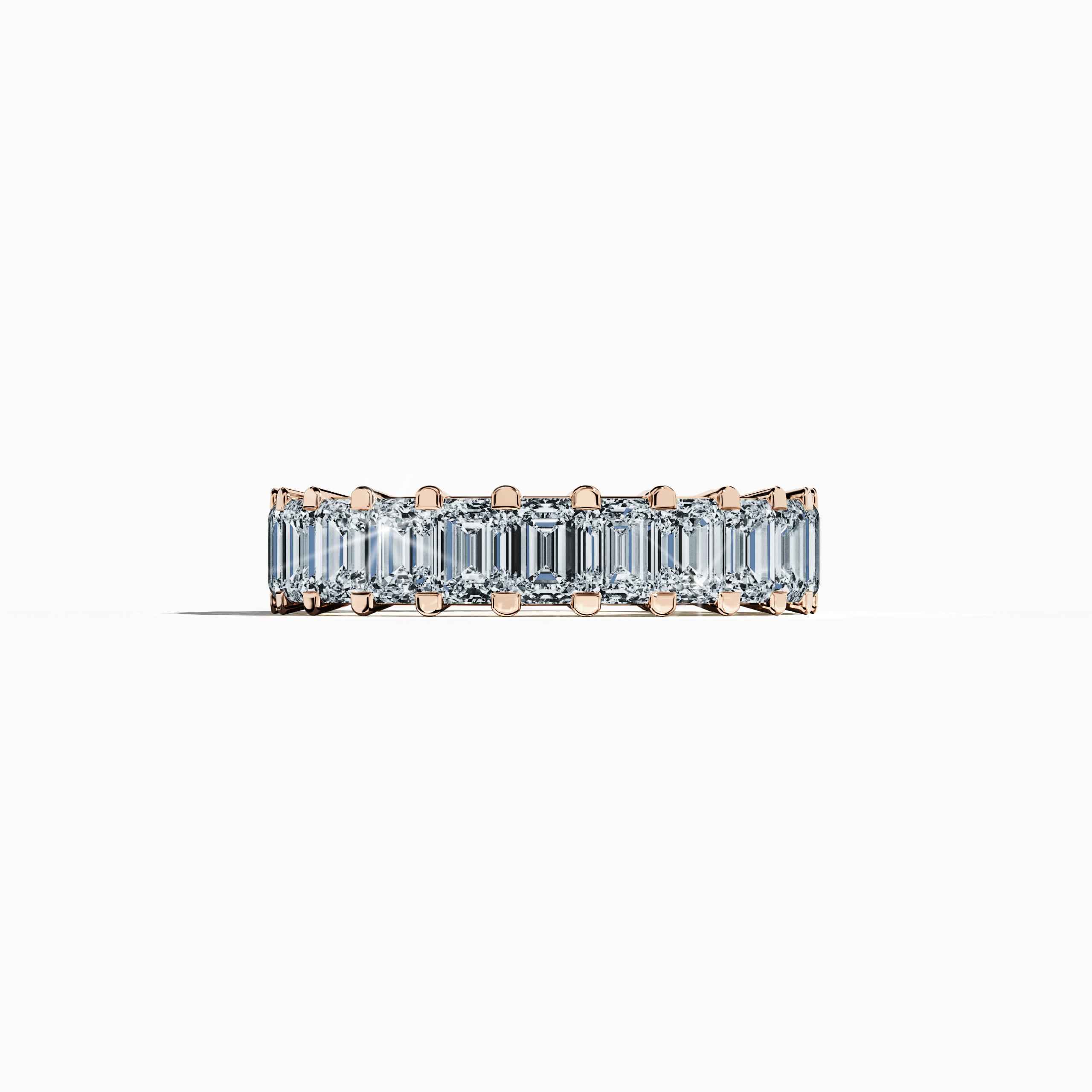 Captured in a delicate sleeping front view, this striking Emerald Eternity ring features a warm rose gold band, also celebrated as pink or blush gold in diverse design lexicons. Embracing renowned identities such as Eternal Emerald, Infinity Emerald, and Everlasting Allure, it showcases up to 24 dazzling diamonds totaling 4.55 carats, gracefully encircling a vivid emerald centerpiece. Keywords: luxury, fine jewelry, innovative design, timeless elegance, refined craftsmanship.