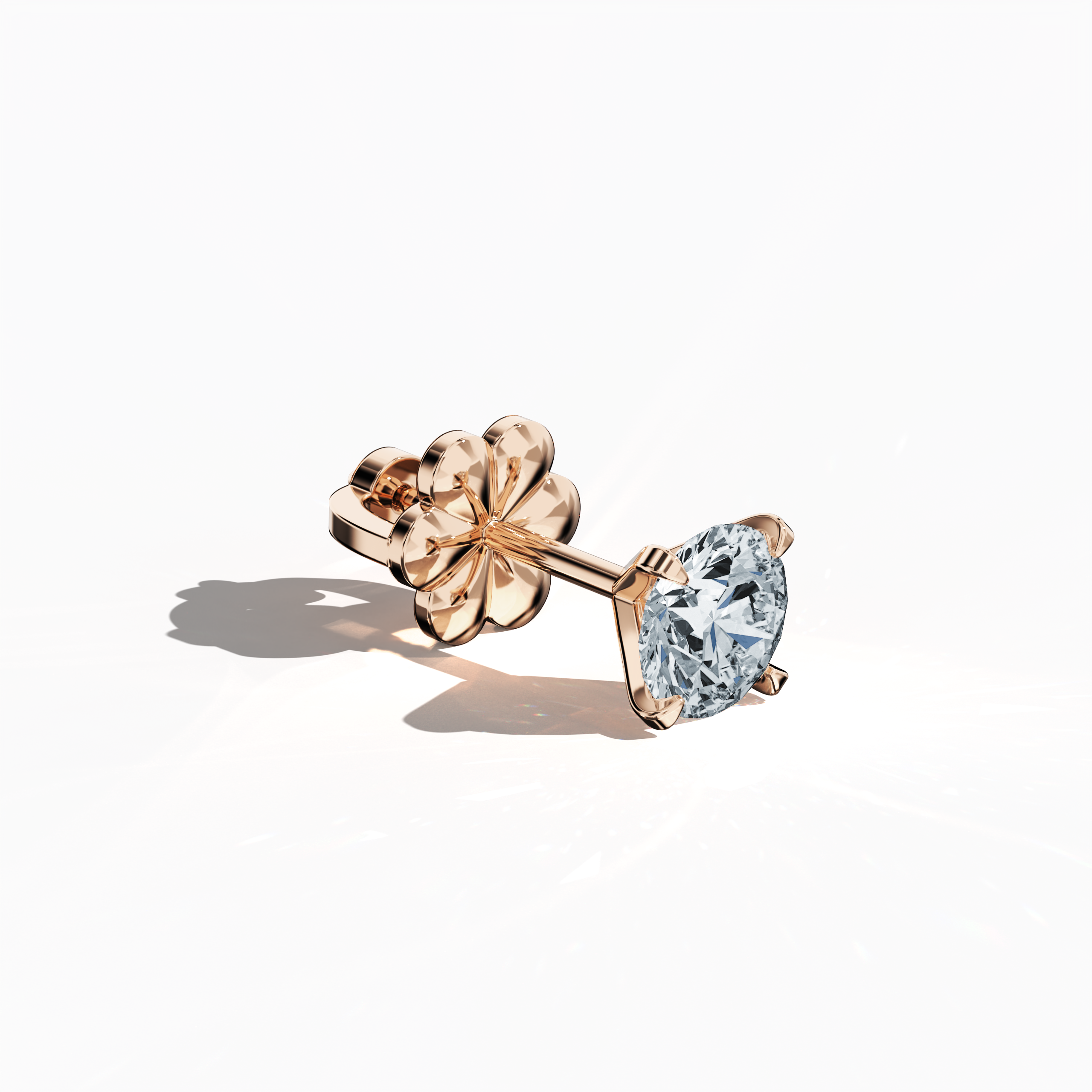 Front top side view of 1.40 carat natural diamond earring in 18k rose gold with nail prong setting; diamond stud, 1.40ct solitaire diamond, luxury fine jewelry/fine jewellery ear accessory.