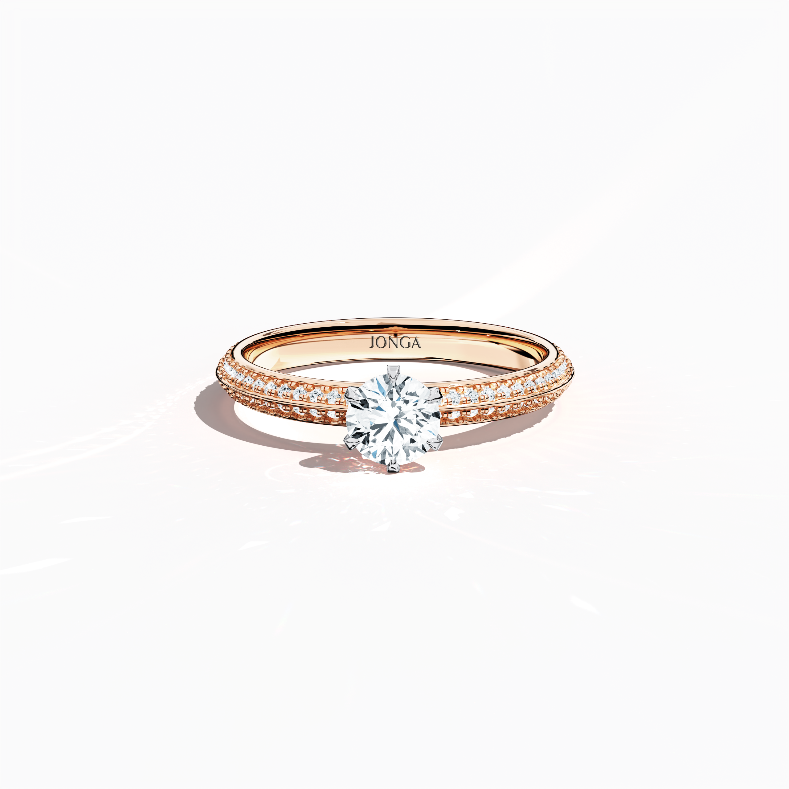 Elegant 0.90 ct diamond ring in a six‑prong setting with a pavé band – including a 0.50 ct center diamond and 0.40 ct side stones – rendered in soft rose gold (blush/pink gold) with a dual‑tier, step‑accented band and a defined central line. Captured from a front top view, this fine jewelry/fine jewellery ring highlights its luminous pavé setting and gentle, romantic finish.