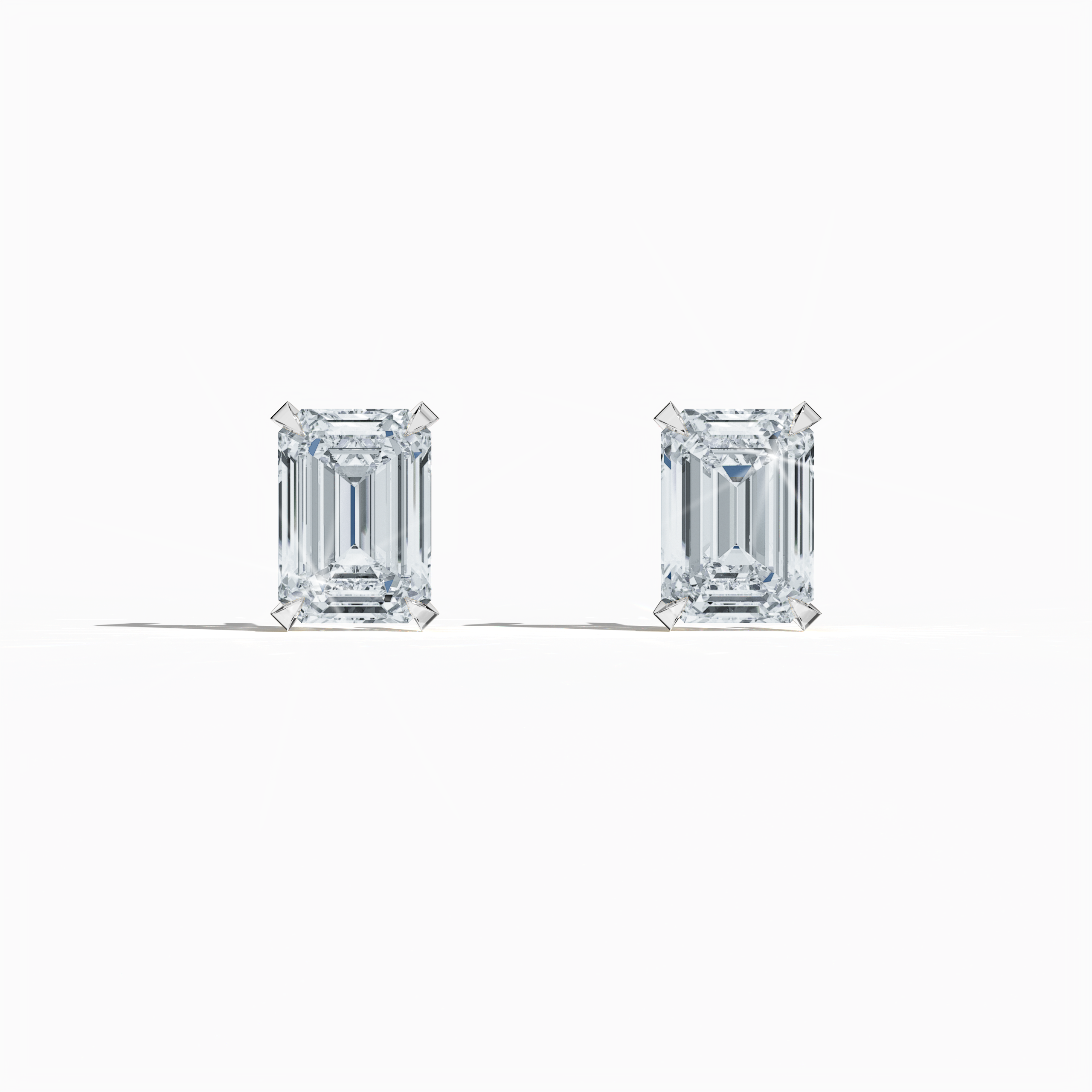 Front view of 1-carat natural emerald earring in 18k white gold with prong setting; emerald stud, 1ct natural emerald, luxury fine jewelry/fine jewellery ear accessory.
