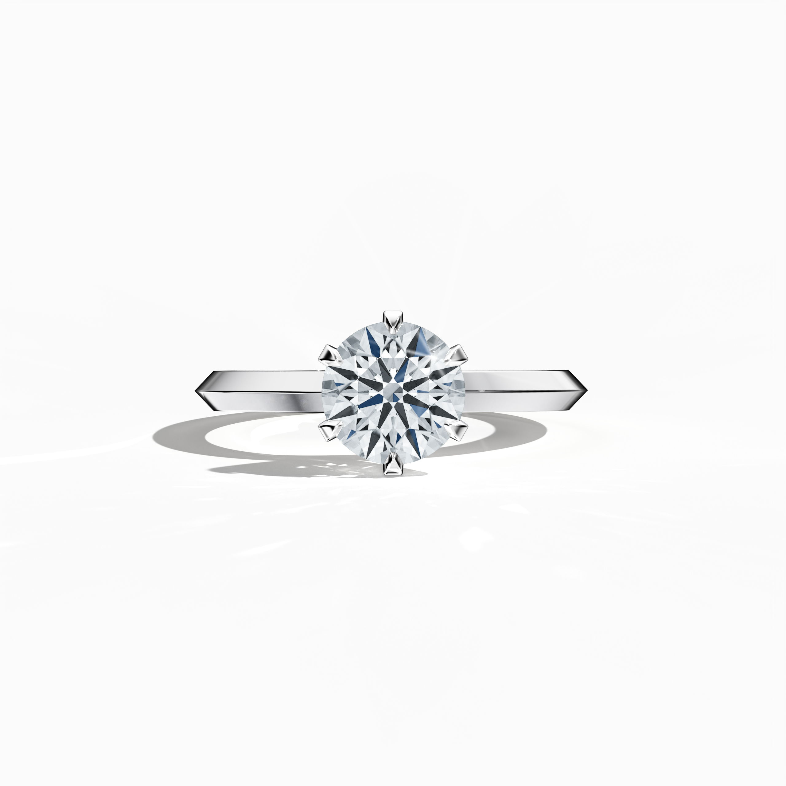 Solitaire diamond ring with a 1 carat center stone in a six-baby claw prong setting and a dual-step band with a sharp central line, set in a bright white gold band. Displayed in a sleeping front view on a flat surface, highlighting its clean lines and luminous design as a refined piece of fine jewelry/fine jewellery.