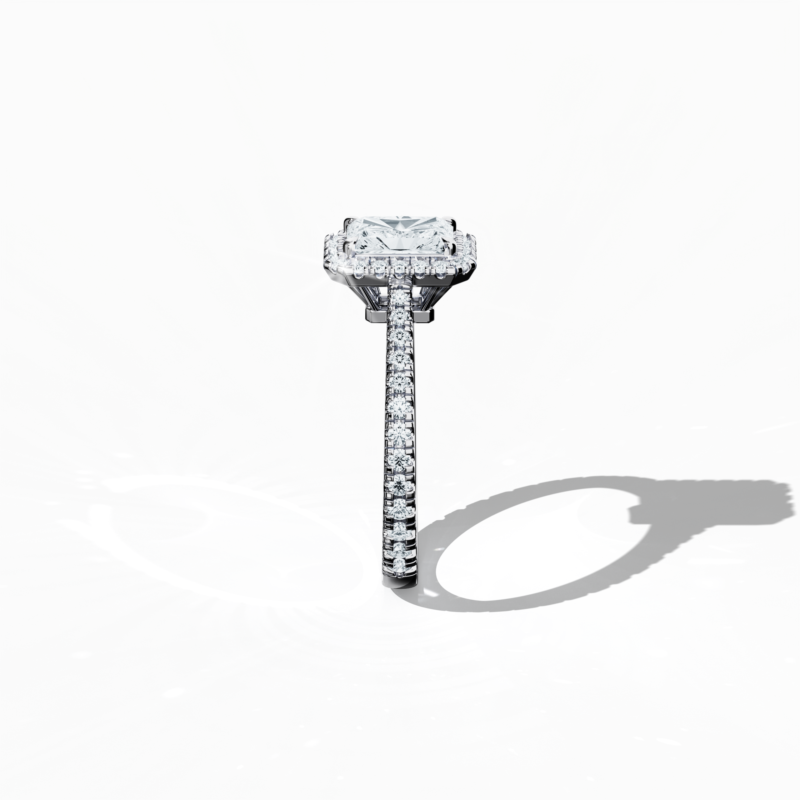 Detailed standing side view of a white gold halo paved ring, accentuating its graceful profile and curved band featuring a 1 carat radiant-cut center diamond complemented by a 0.60ct side diamond halo. The lateral angle reveals intricate pavé detailing in white, silver, and pale gold, fusing classic halo, vintage halo, modern halo, and bridal halo aesthetics. Keywords: luxury, refined craftsmanship, radiant brilliance, elegant design, modern sophistication.