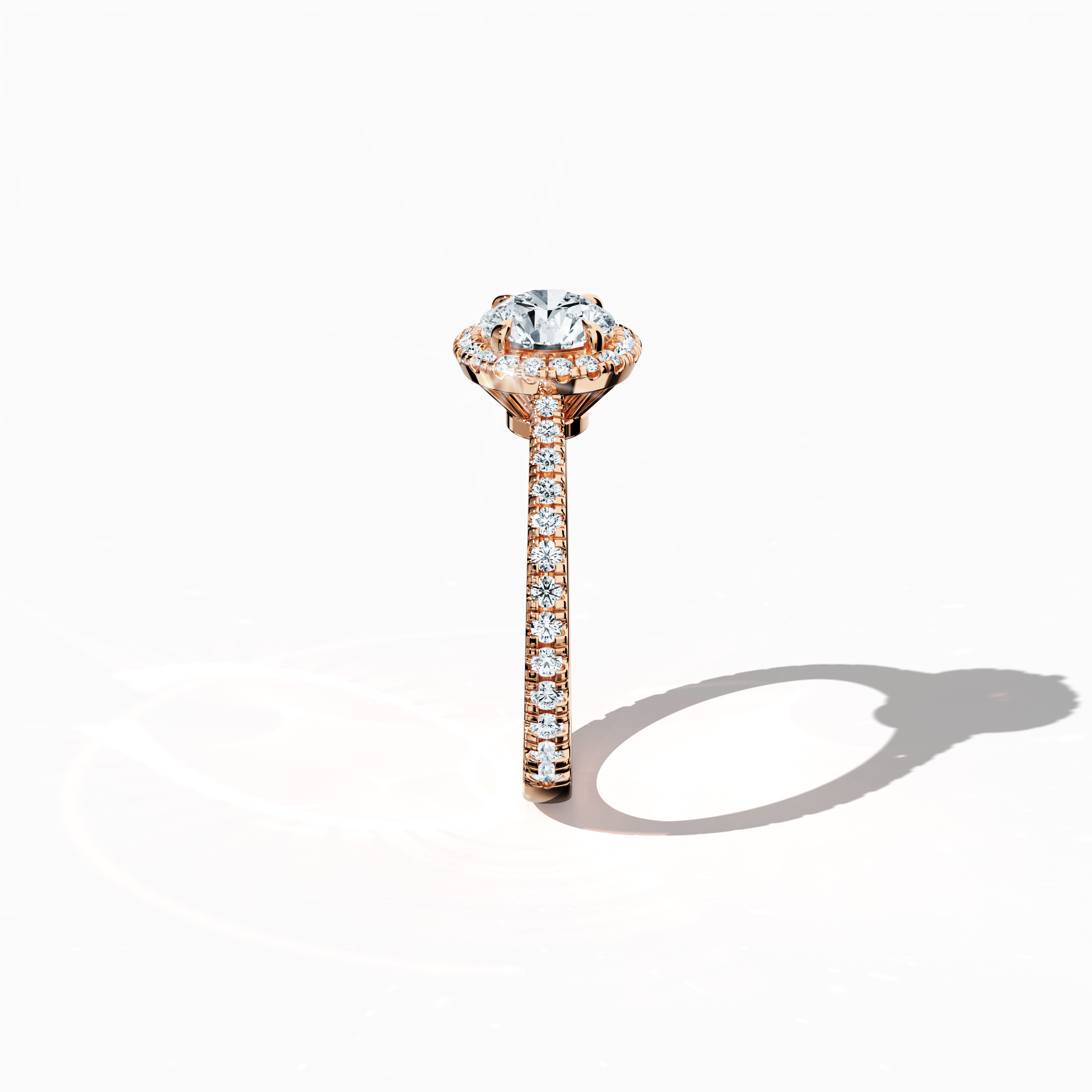 Detailed standing side view of a rose gold halo paved ring accentuating its elegant profile and gracefully curved band featuring a 1ct round‐cut center diamond paired with a 0.60ct side diamond halo. The lateral angle reveals intricate pavé details in warm rose, pink, and blush gold, blending influences of classic halo, vintage halo, modern halo, and bridal halo designs. Keywords: refined, round brilliance, artisanal, luxury, contemporary style.