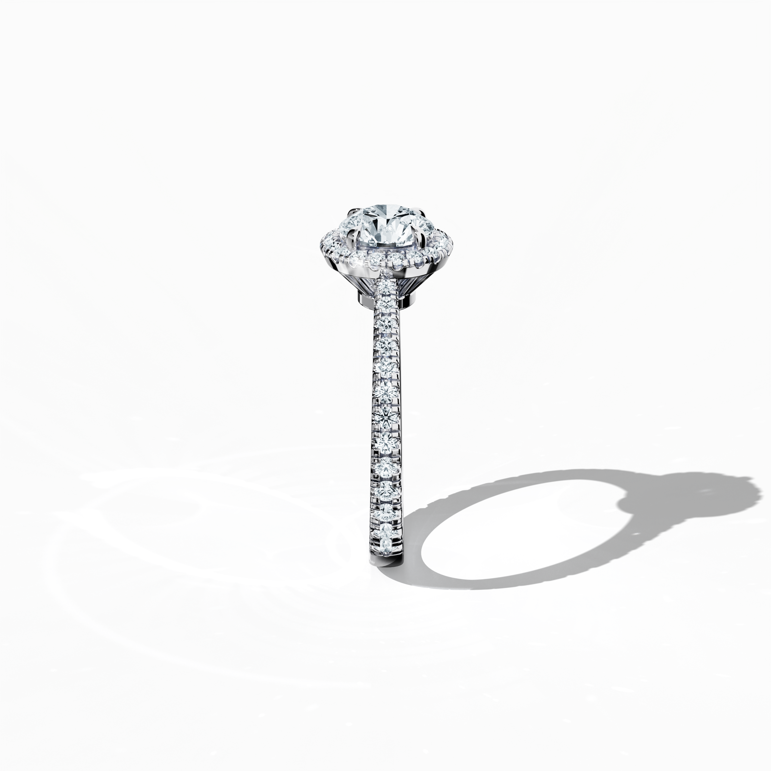 Detailed standing side view of a white gold halo paved ring accentuating its elegant profile and gracefully curved band featuring a 1ct round‐cut center diamond paired with a 0.60ct side diamond halo. The lateral angle reveals intricate pavé details in white, silver, and pale gold tones, blending influences of classic halo, vintage halo, modern halo, and bridal halo designs. Keywords: refined, round brilliance, artisanal, luxury, international style.