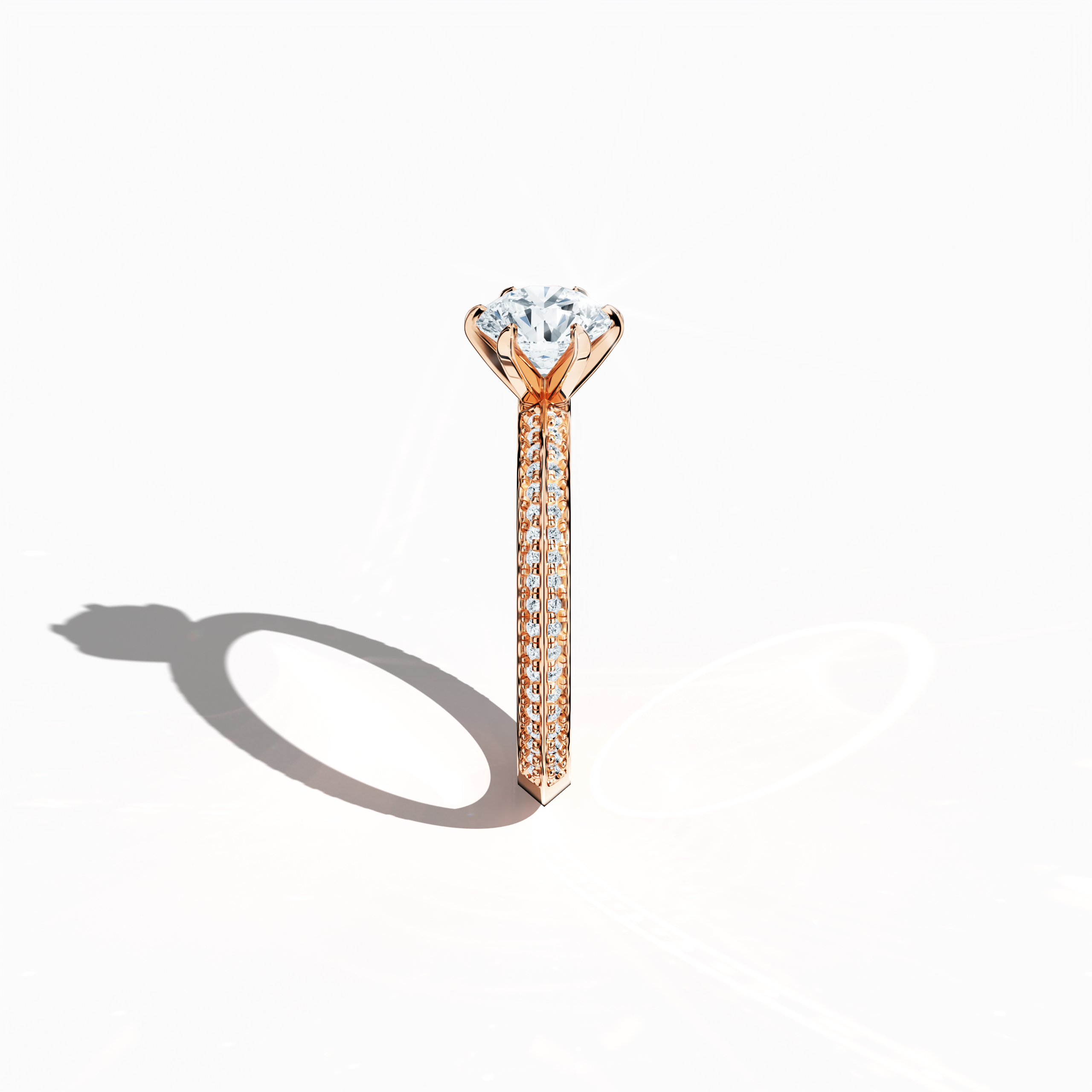 Refined solitaire paved ring with 1.40 ct diamonds – a 1 ct center diamond and 0.40 ct pavé side stones – set in soft rose gold (blush/pink gold) with a two‑step band featuring a sharp central accent. Photographed from a standing side view, this fine jewelry/fine jewellery ring showcases elegant contours and warm, romantic allure.