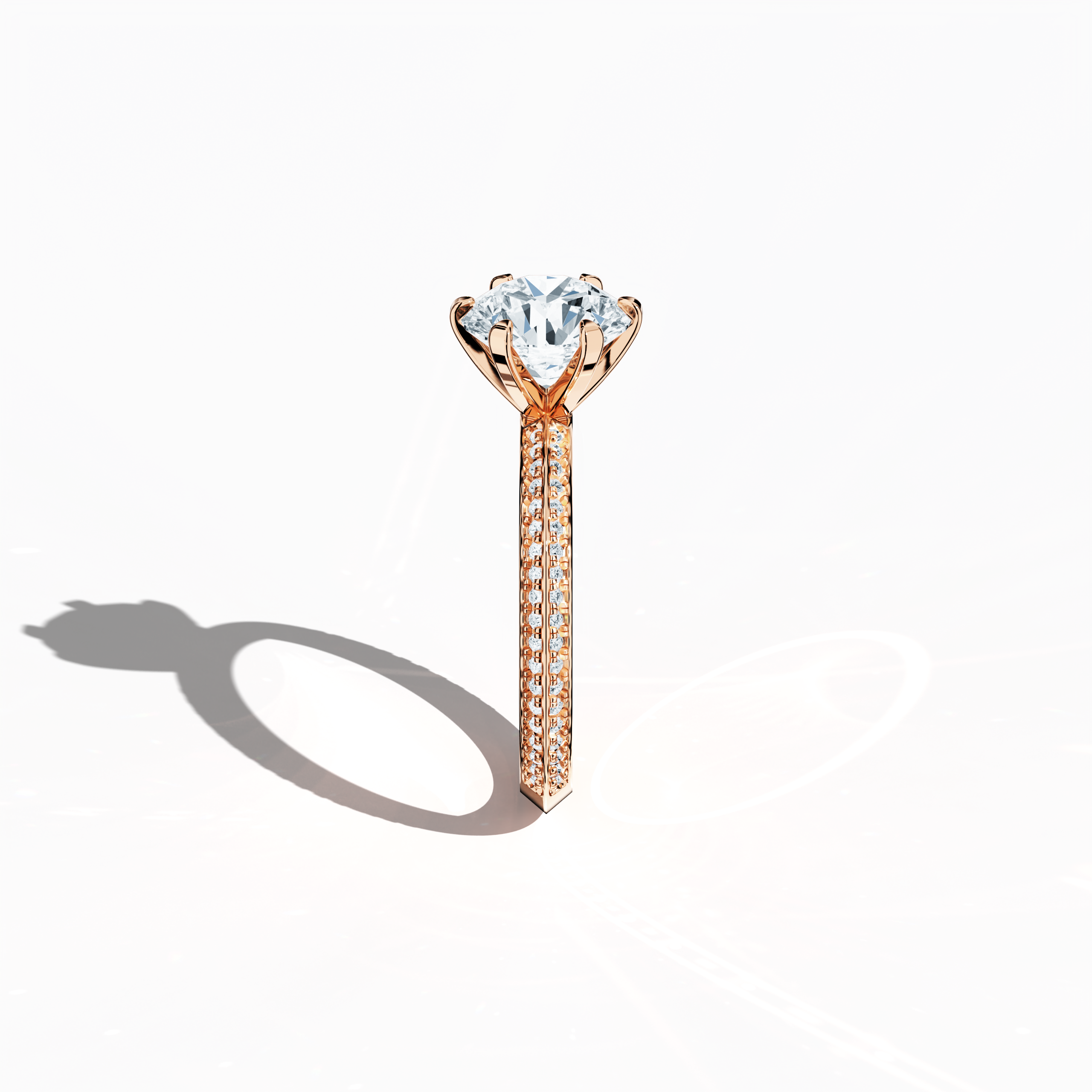 Refined solitaire paved ring with 2.40 ct total diamonds (2 ct center, 0.40 ct side stones) in a six‑prong setting and a two‑step band with a sharp central line, set in soft rose gold (blush/pink gold). Photographed from a standing side view, this fine jewelry/fine jewellery ring showcases its elegant contours and warm, romantic allure.