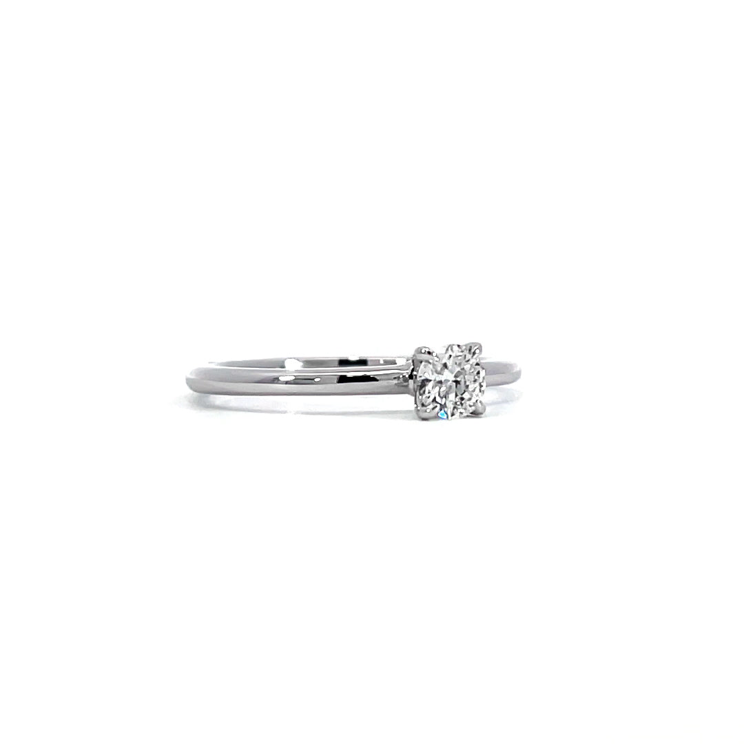 Simple solitaire ring showing 0.26 carat D-F color VVS-VS clarity diamond in classic solitaire setting 18K white gold
