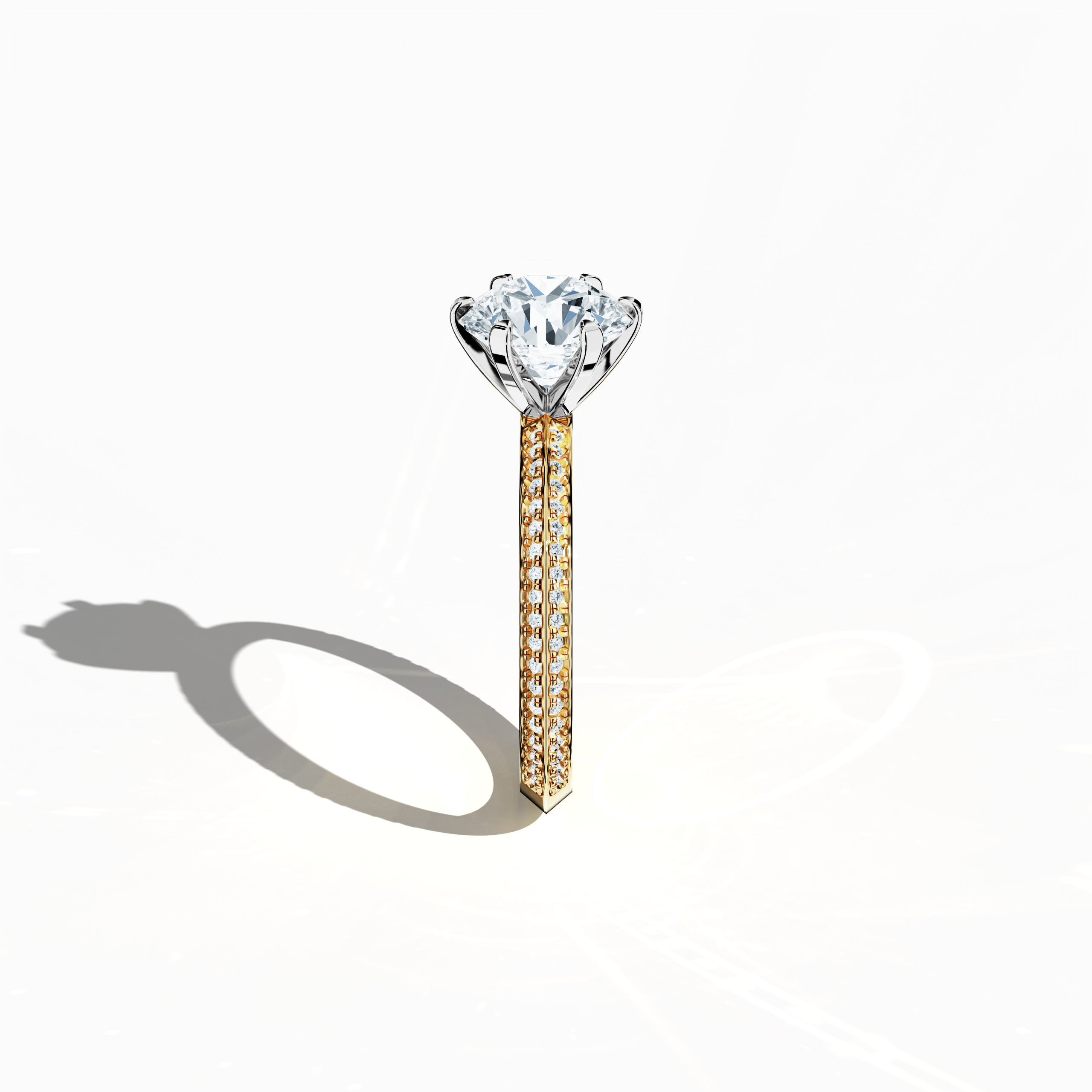 Refined solitaire paved ring with 2.40 ct total diamonds (2 ct center, 0.40 ct side stones) in a six‑prong baby claw setting and a two‑step band with a sharp central line, set in a rich yellow gold band. Photographed from a standing side view, this fine jewelry/fine jewellery ring showcases its elegant contours and vibrant, warm finish.