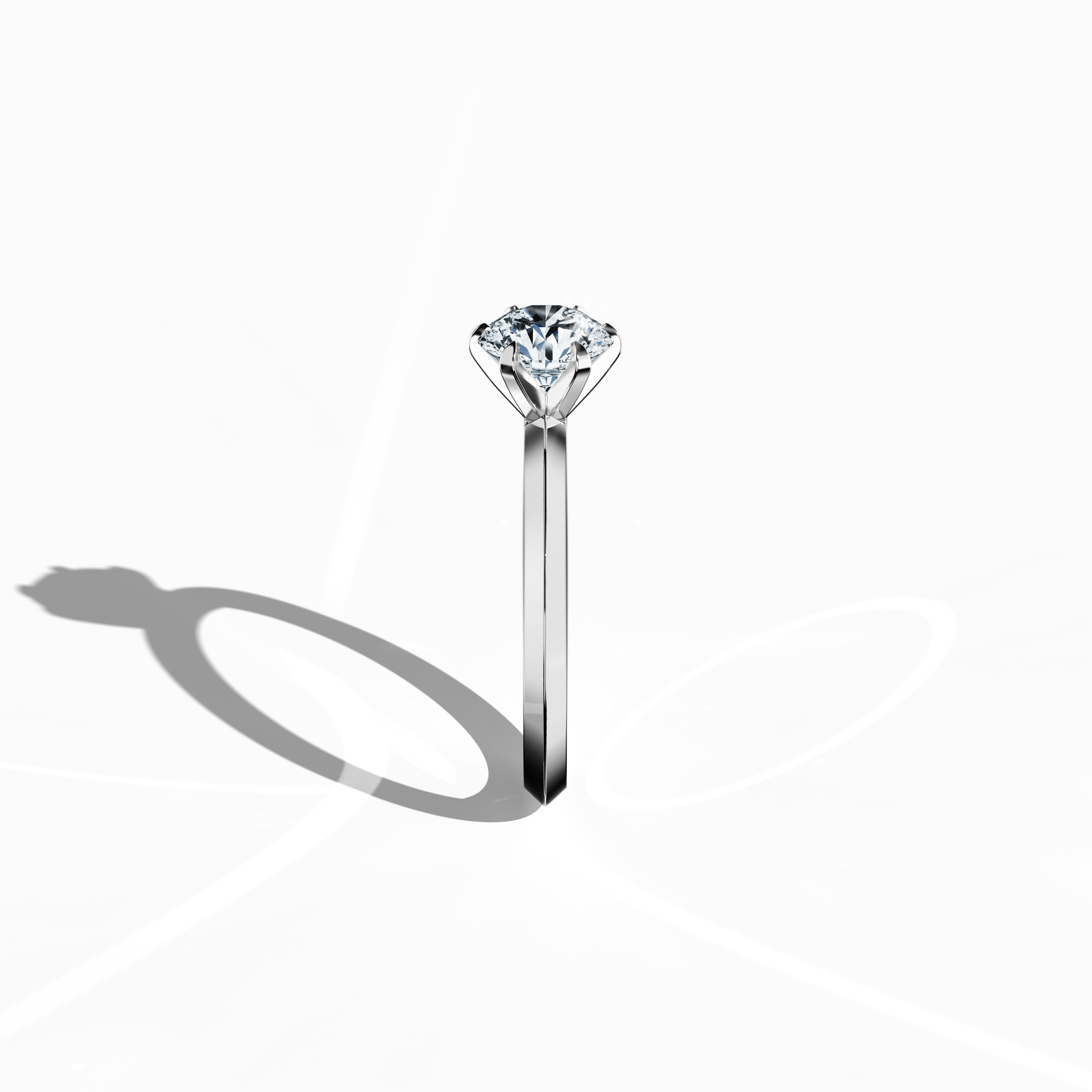 Elegant solitaire diamond ring with a 1 carat center diamond in a six-baby claw prong setting and a dual-level band with a sharp midline, set in a bright white gold band. Captured from a standing side view, this refined fine jewelry/fine jewellery piece showcases its graceful contours and prong detailing