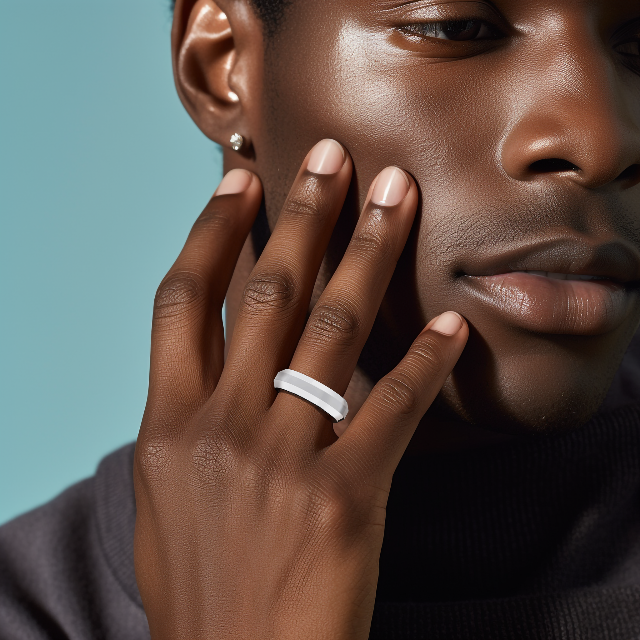 Photograph of an elegant three‐step design white gold (luminous white, sterling white) wedding band, meticulously crafted with a 6.5mm width featuring a striking matte‐finished central step flanked by brilliant glossy outer steps. This tiered, triple‐tier, layered, stepped, and graduated step band radiates modern luxury, exceptional artistry, and timeless appeal. Worn on him finger and captured with soft focus, keywords include white gold, matte, glossy, wedding band, and innovative design.