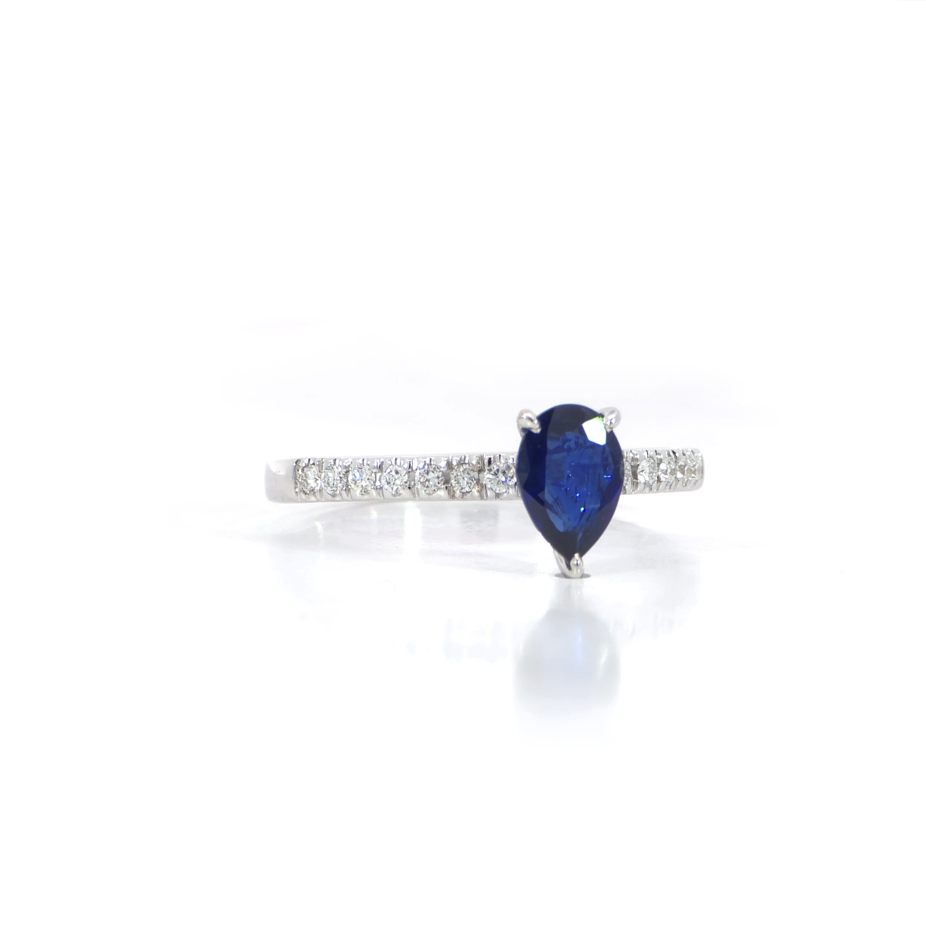 Pear Blue Sapphire Paved Ring side view showing 0.61 carat pear cut blue sapphire with pave diamonds 18K white gold
