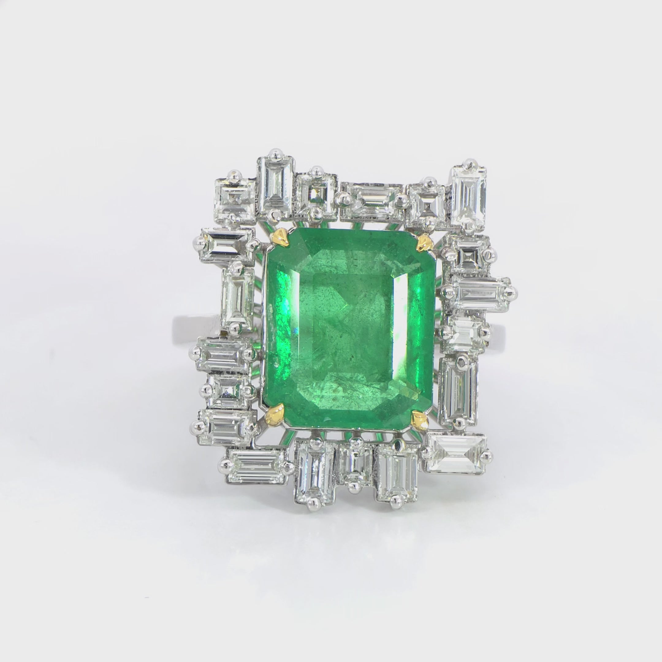 Green Emerald with tapered baguette halo ring video 6.32 carat IGI certified emerald 1.67 carat D-F color VVS clarity diamonds white gold craftsmanship
