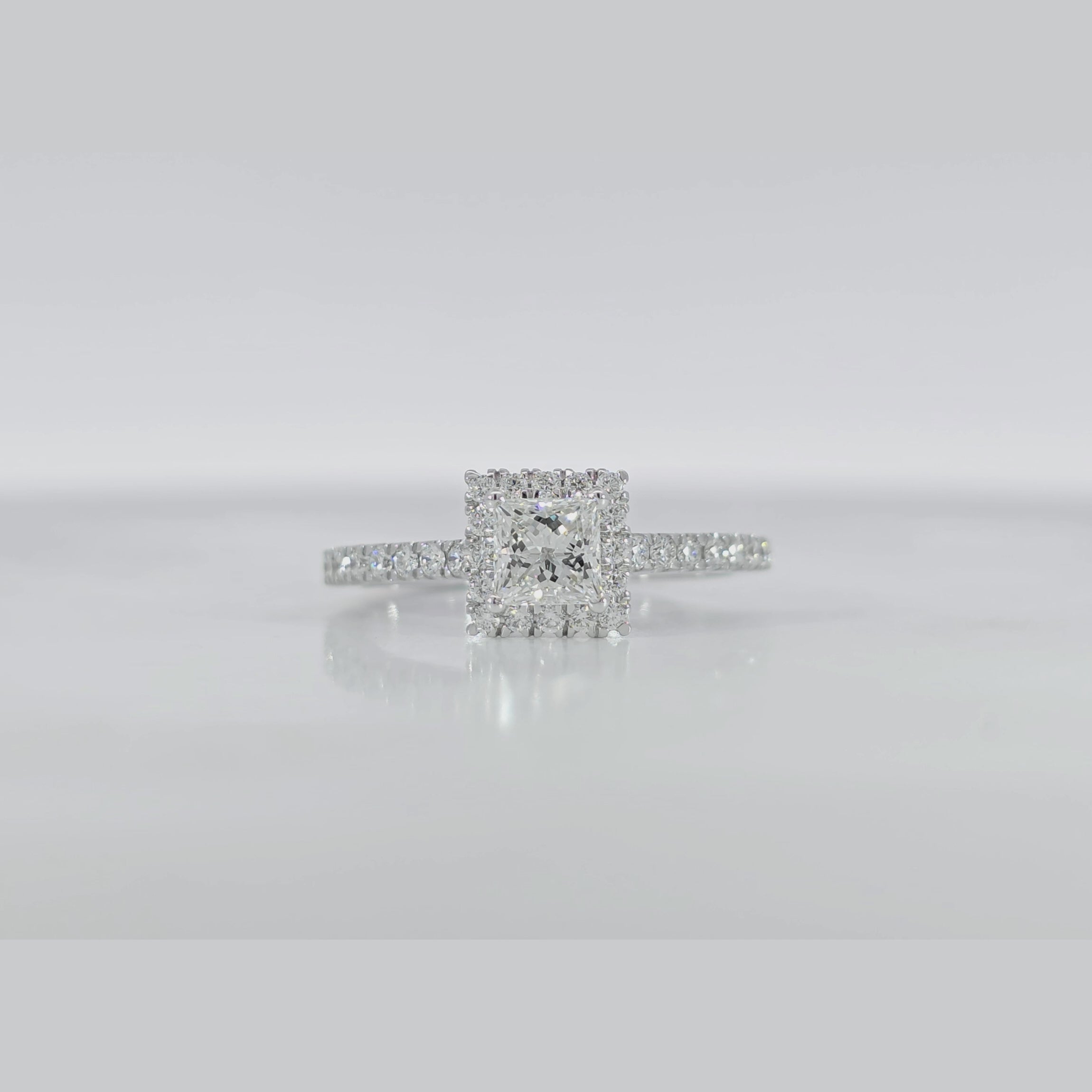 Halo Princess Ring video displaying GIA certified VVS clarity princess cut diamond and luxury white gold finish
